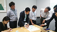 Photo Employees discussing the work-style innovation project.
